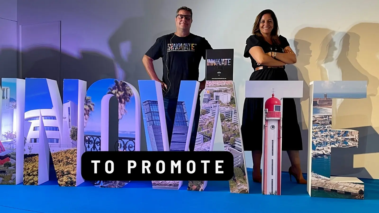 Partners standing on giant INNOVATE letters with their book. Caption: To promote.